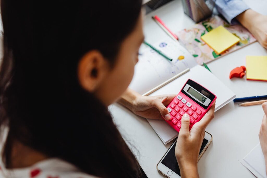 Girl Using a Red Calculator